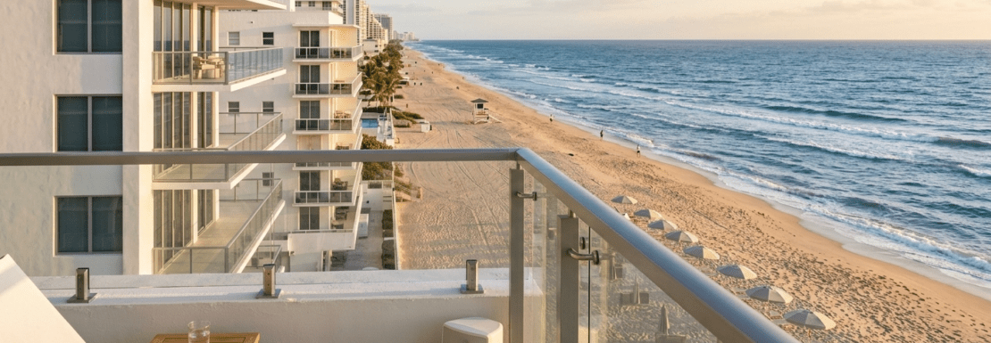 Realistic balcony view from a Galt Ocean Mile high-rise in 2026, overlooking the Atlantic Ocean and the line of luxury beachfront condominiums in Fort Lauderdale.
